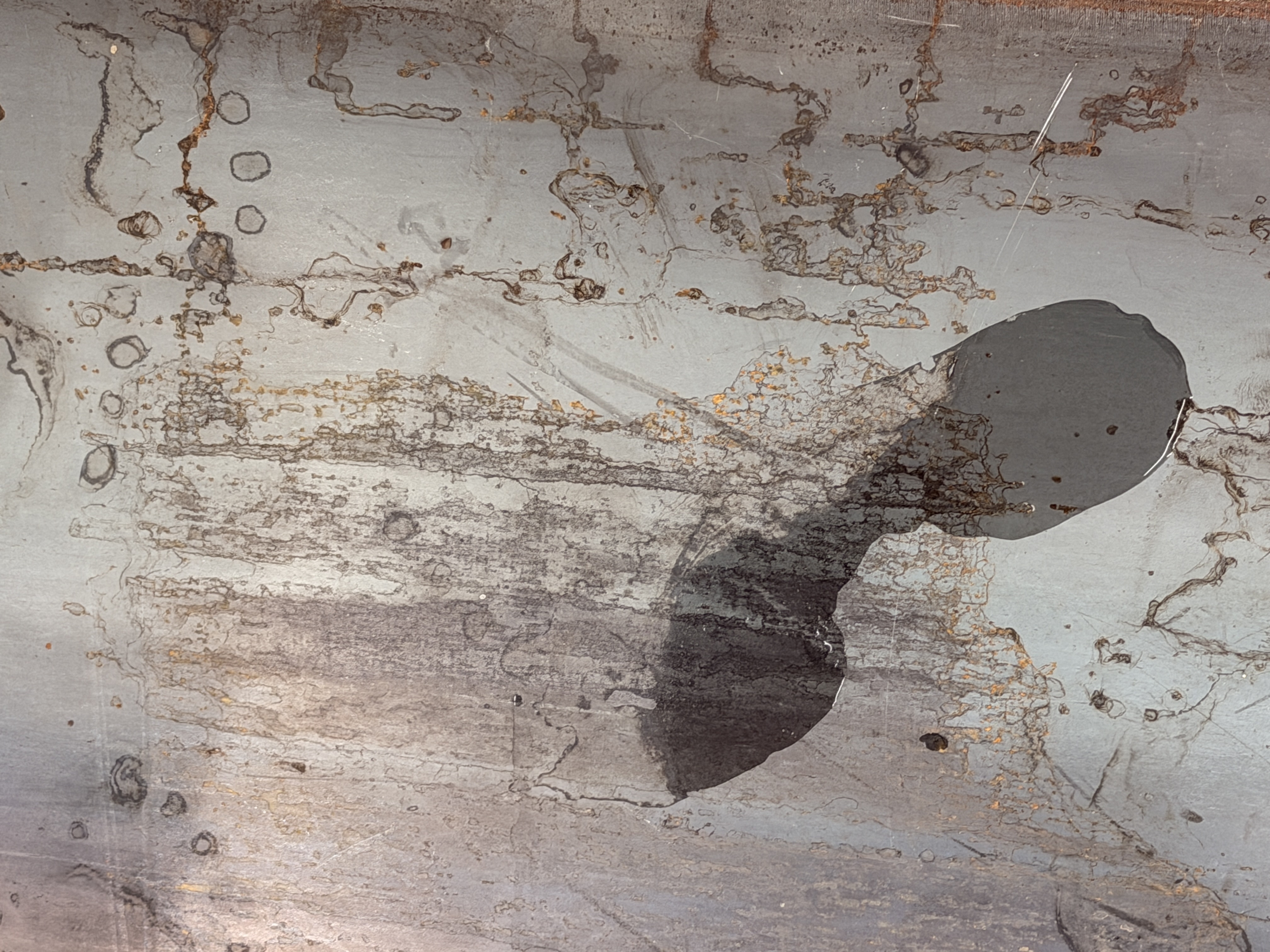 The Wake of the Body by oneg - ephemeral wet footprint traces on steel surface exploring presence and absence